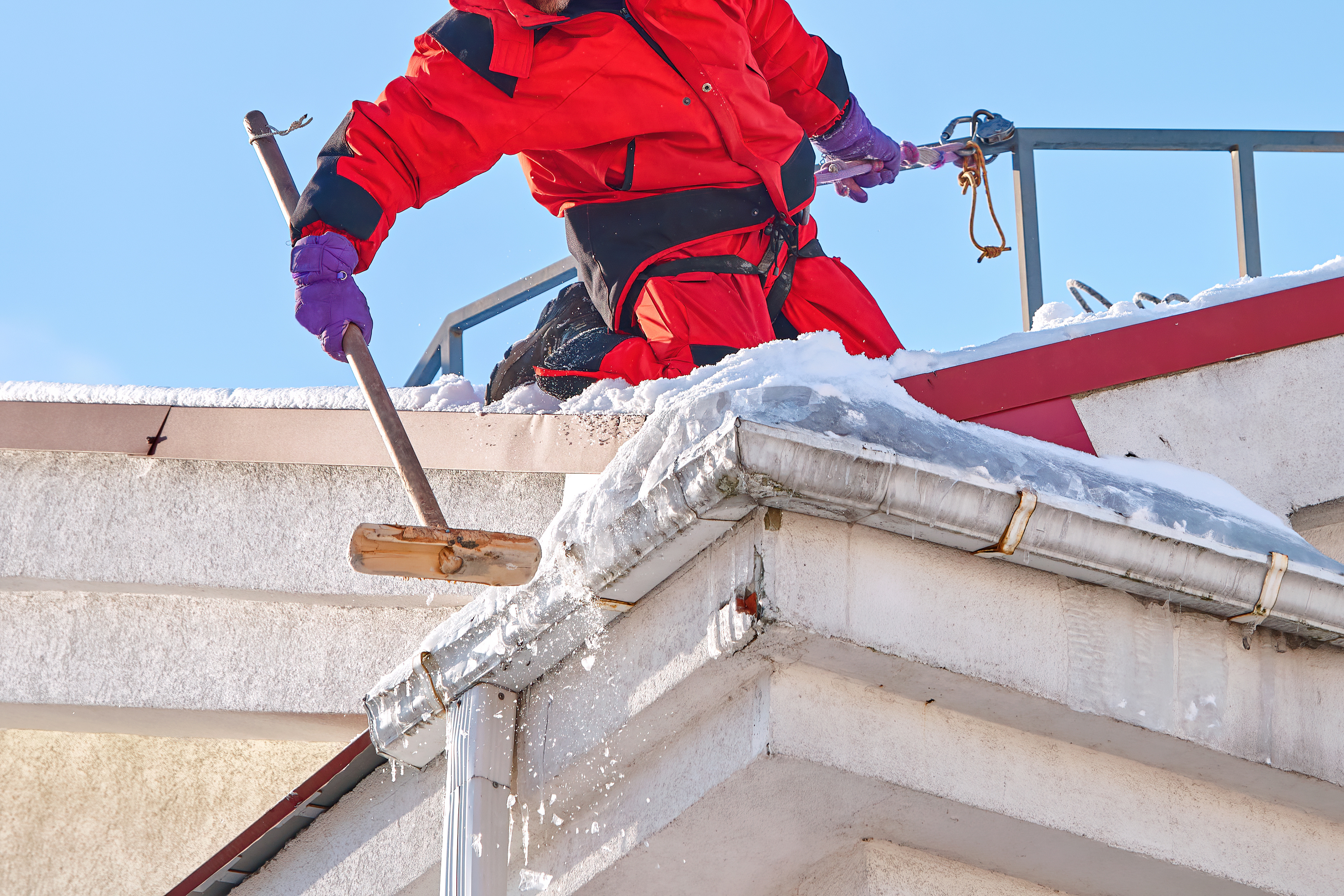 A Window Ninjas professional clearing an ice dam with gutter cleaning in Raleigh, NC.