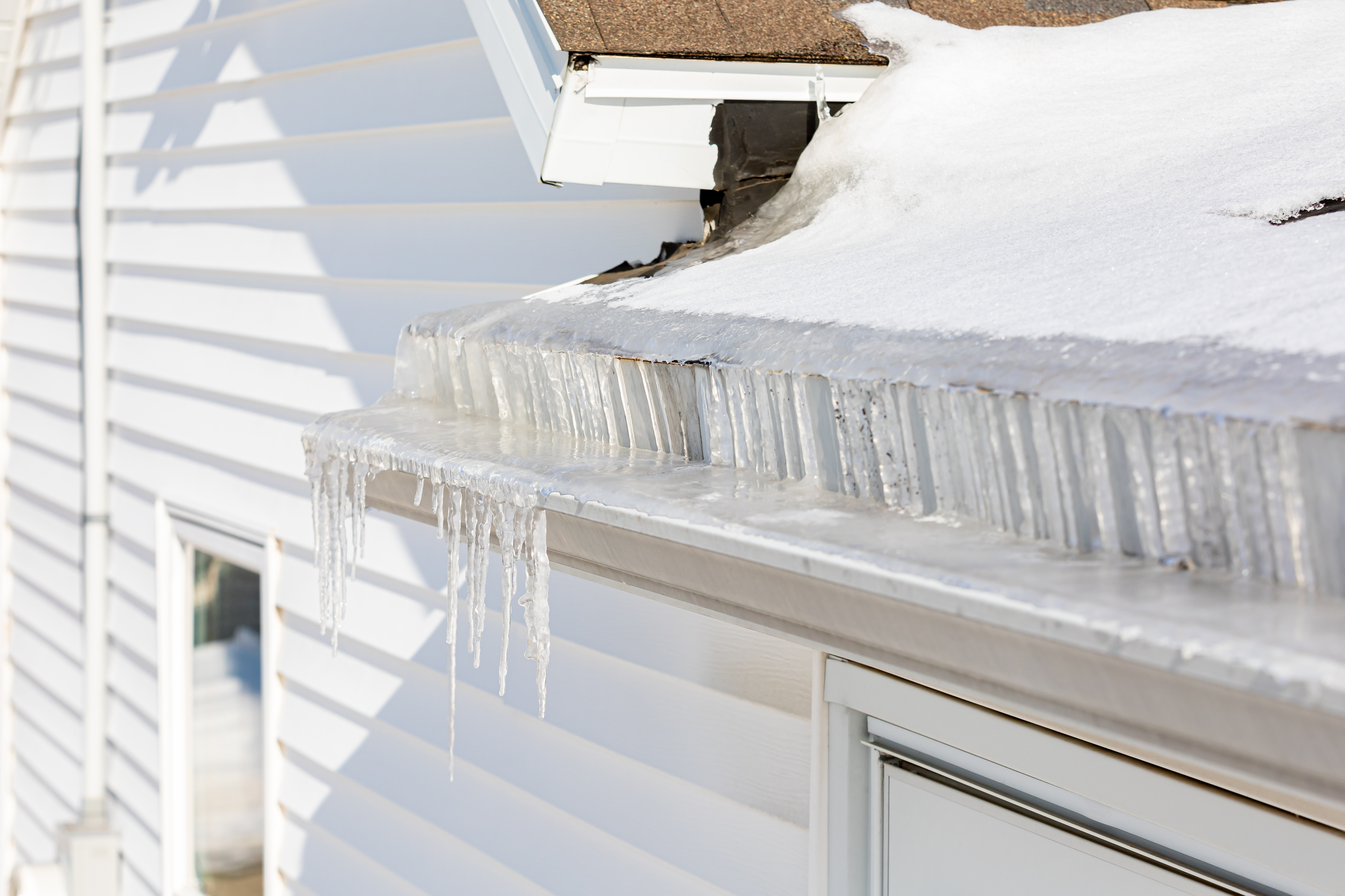 A picture of an ice dam blocking a gutter - prevent ice dams with gutter cleaning in Raleigh, NC from Window Ninjas