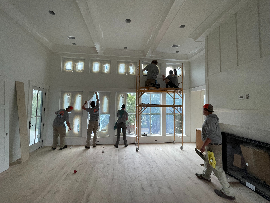 A team from Window Ninjas Charlotte working on cleaning windows in a post-construction home.