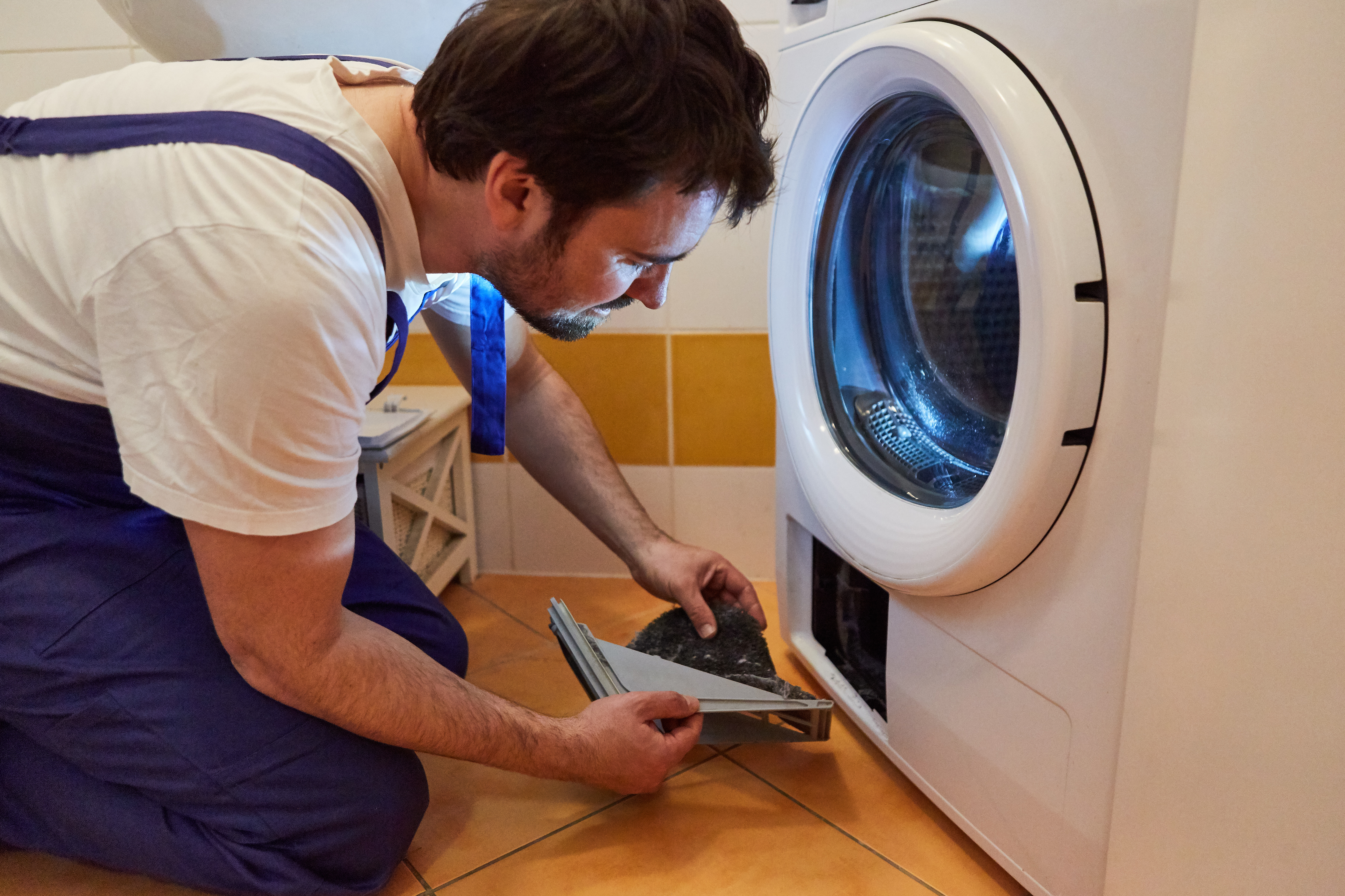 A technician from Window Ninjas Nashville starting a dryer vent cleaning job.