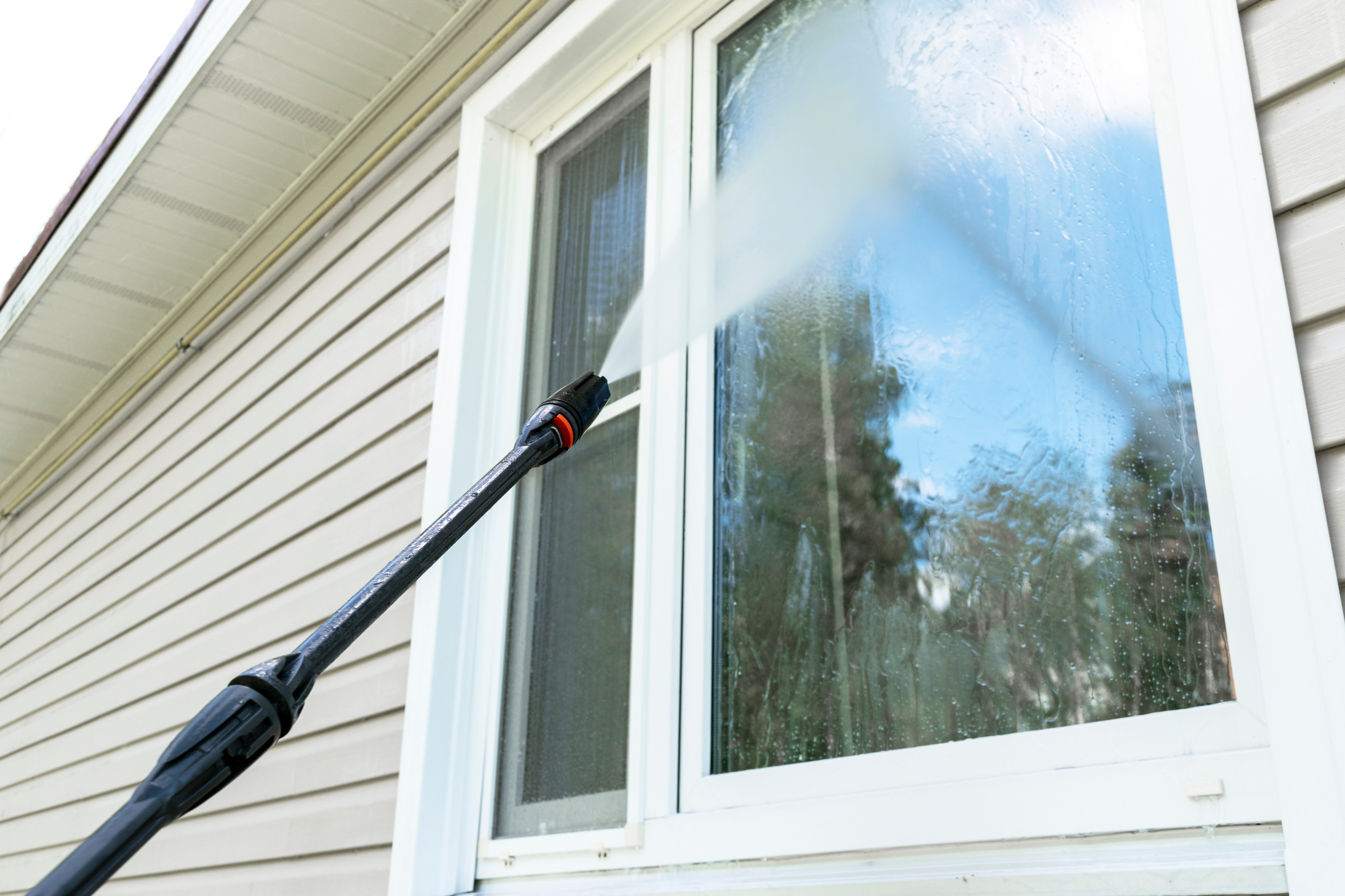 An image of pressure washing for a window - contact Window Ninjas today, your expert window power washers.