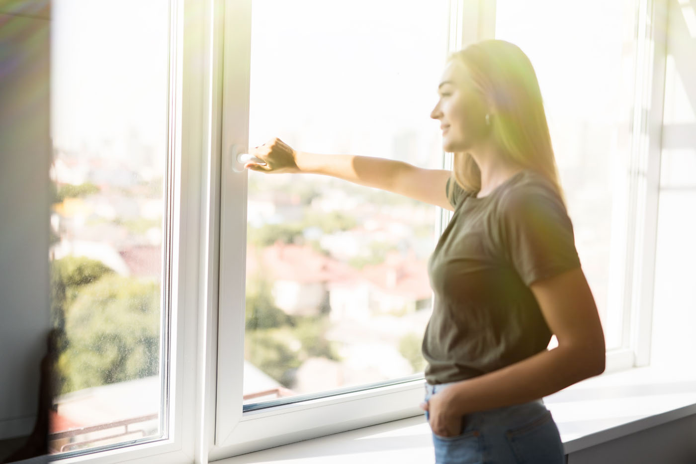 A woman enjoying the benefits of her affordable window cleaning from Window Ninjas Wilmington.