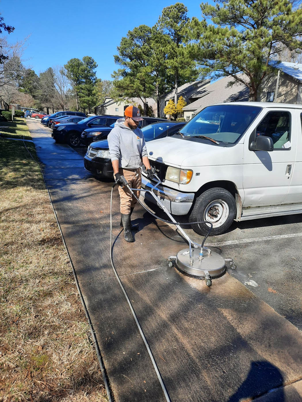 A Window Ninjas Nashville employee effectively cleaning a sidewalk with our Nashville pressure washing services and advanced technology.