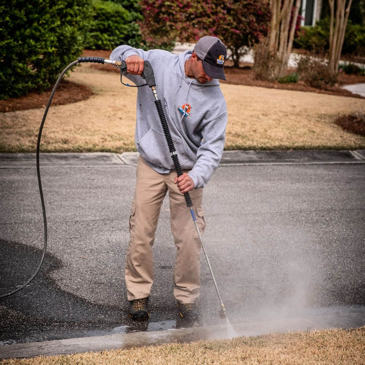 Window Ninjas Charlotte technician performing power washing.