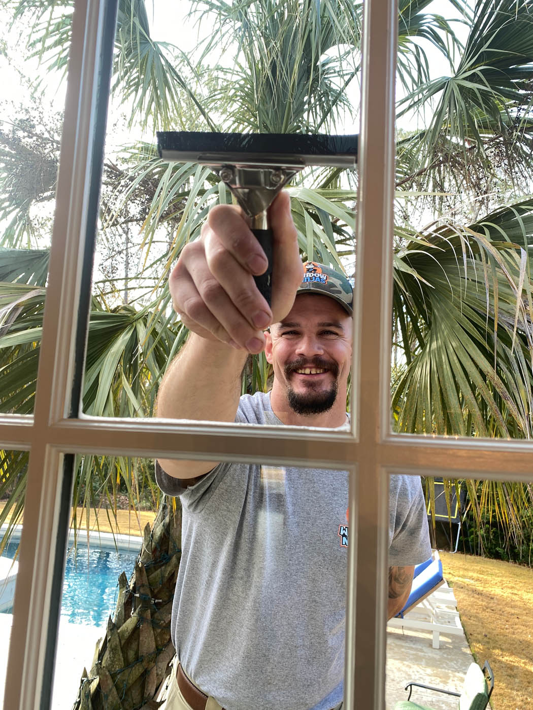 Window Ninjas technician providing window washing services.