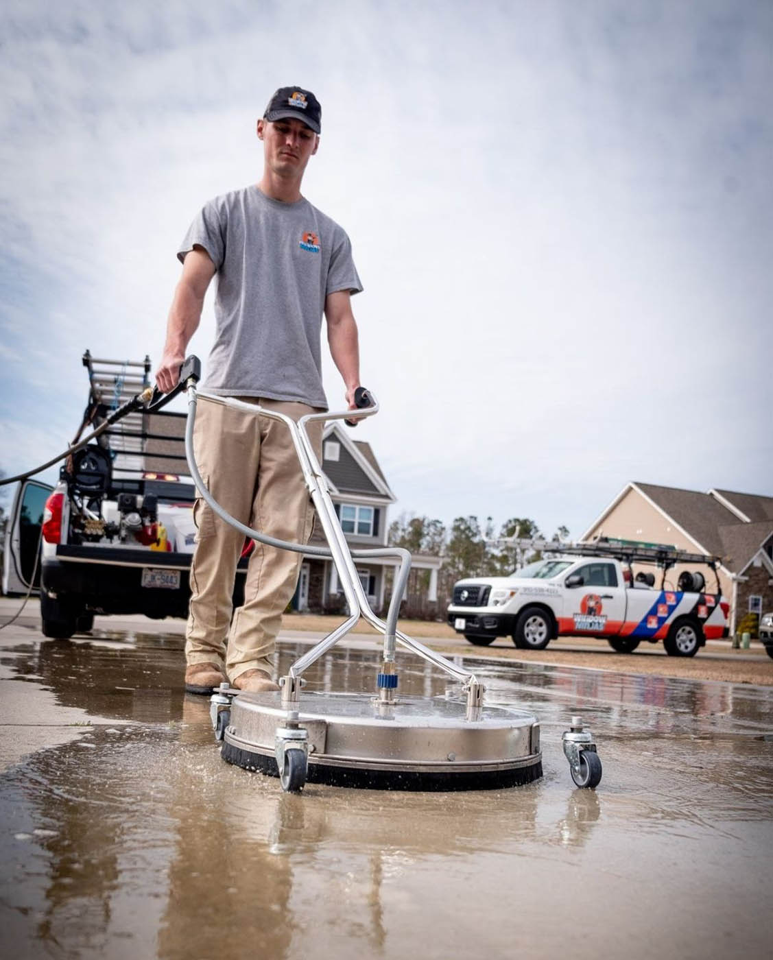 A professional power washing technician providing services for a concrete surface - Window Ninjas Nashville.