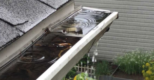 clogged gutters with water spilling over