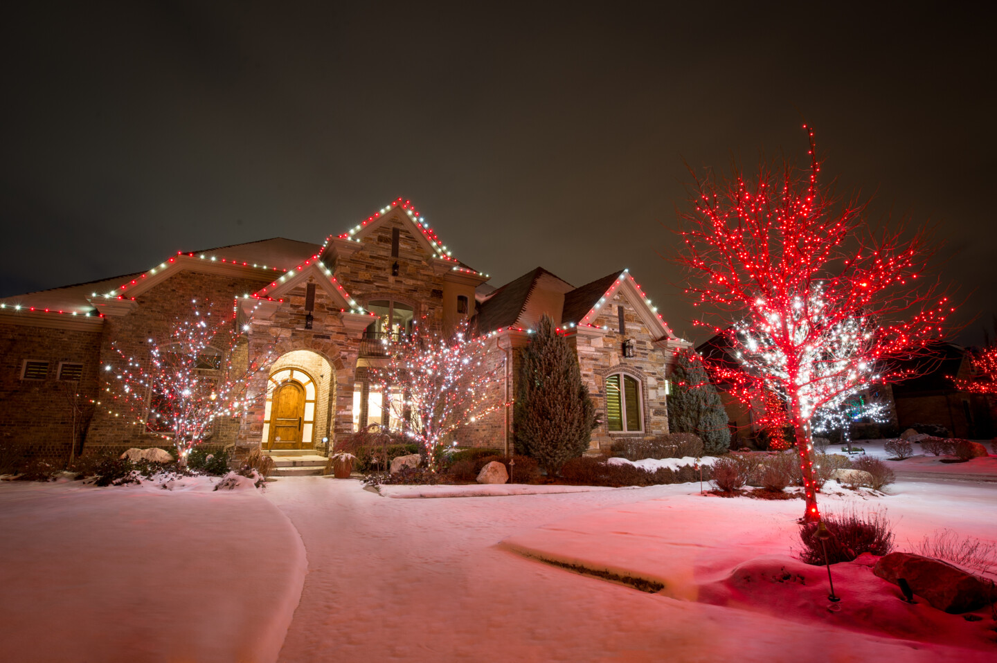 House with professional holiday lights in red and white